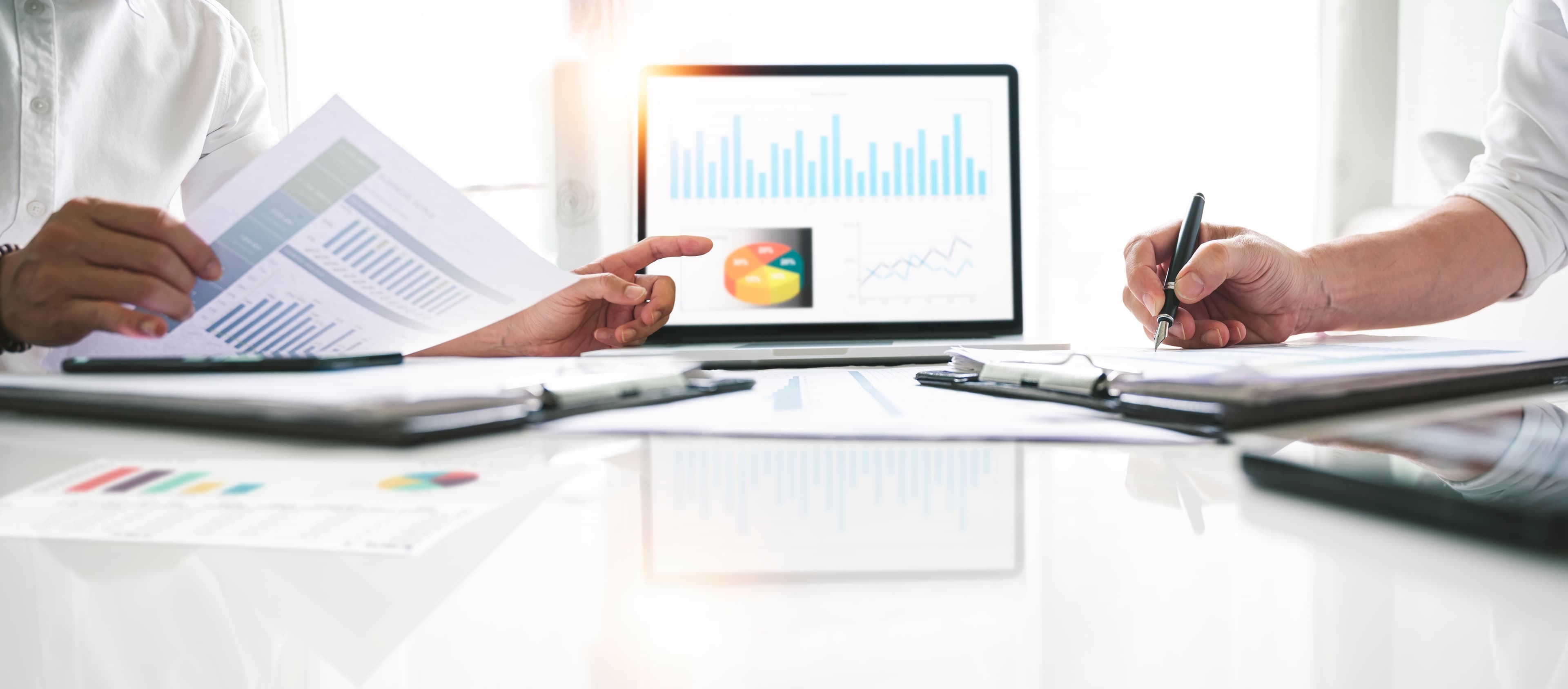 Two professionals reviewing intake materials and financial information together.