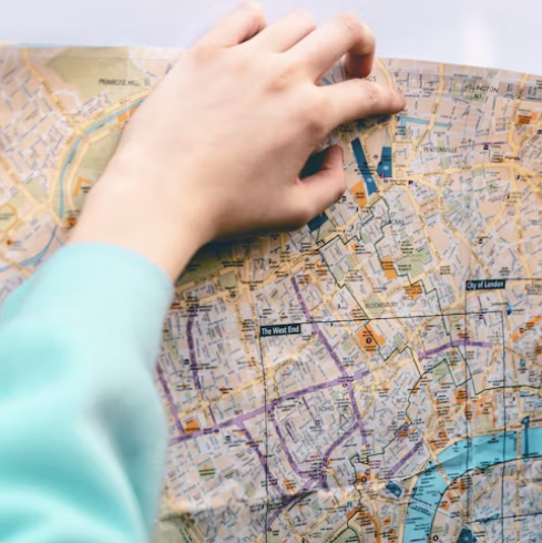 Person holding and reading a map to navigate directions